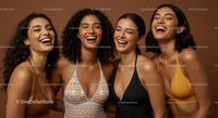 Group of Joyful Women Laughing in Colorful Swimwear