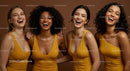 Joyful Group of Women Laughing in Yellow Dresses