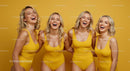 Group of Laughing Women in Vibrant Yellow Swimsuits