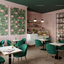 Chic Cafe Interior with Green Velvet Chairs and Floral Art