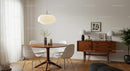 Scandinavian Dining Room with Wooden Round Table and Plants
