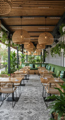 Modern Cafe Interior with Green Plants and Rattan Decor