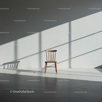 Wooden Chair in Sunlit Minimalist Room with Shadows