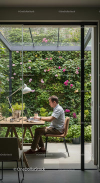 Man Working from Home Office with Vibrant Garden View