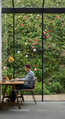 Man Working on Laptop with Scenic Garden View