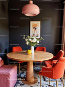 Modern Dining Room with Pink Lamp and Orange Chairs