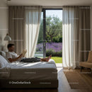 Man Relaxing in Bedroom with Lavender Garden View
