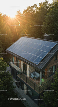 Modern House with Solar Panels in Forest Setting at Sunset