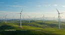 Wind Turbines Over Rolling Green Hills Under Clear Blue Sky