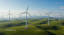 Wind Turbines on Rolling Green Hills Under Blue Sky
