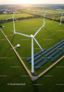 Aerial View of Wind Turbines and Solar Panels on Green Fields
