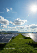 Solar Panels Under Bright Blue Sky in a Green Field