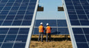Engineers Inspecting Photovoltaic Solar Panels in Solar Farm