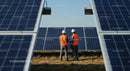 Engineers Inspecting Solar Panels on a Sunny Day