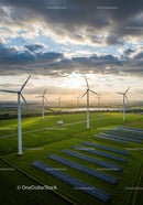 Wind Turbines and Solar Panels in Green Landscape at Sunset