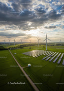 Aerial View of Wind Turbines and Solar Panels at Sunset