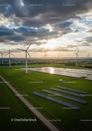 Aerial View of Wind Turbines and Solar Panels in Green Fields