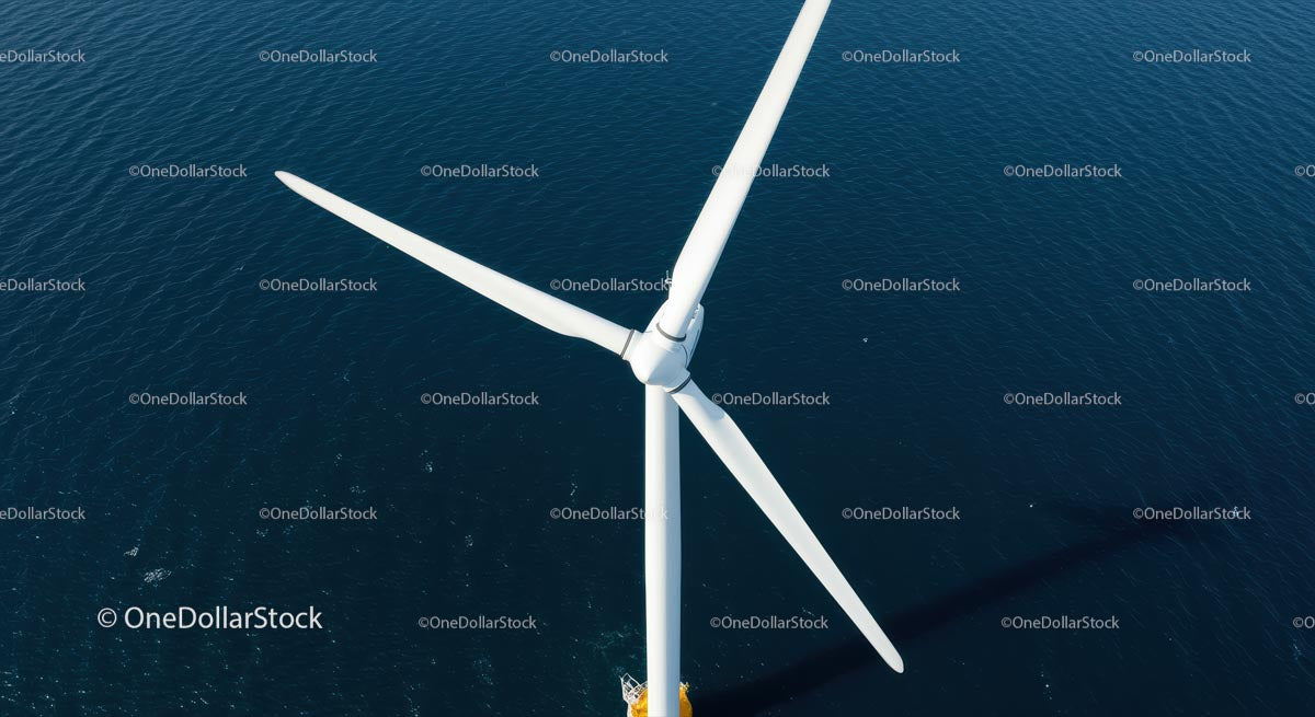 Aerial View of Offshore Wind Turbine Against Deep Blue Sea
