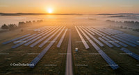Solar Panels at Sunrise in a Misty Countryside Landscape