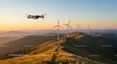 Drone Over Scenic Hills with Wind Turbines at Sunset