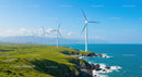 Wind Turbines on Green Coastal Hills Against Blue Ocean