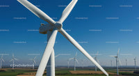 Wind Turbines on a Clear Day in a Vast Field