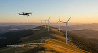 Drone Flying Over Wind Turbines at Sunset in Scenic Hills