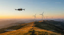 Drone Over Wind Farm at Sunset with Rolling Hills