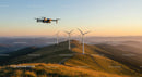 Drone Over Wind Turbines at Sunset in Mountainous Landscape