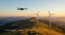 Drone Captures Wind Turbines at Sunset in Mountain Range