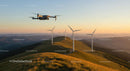 Drone over Wind Turbines at Sunset in Scenic Mountain Range