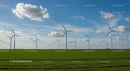 Wind Turbines in a Vast Green Field Under Blue Skies