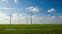 Wind Turbines in a Green Field Under a Blue Sky
