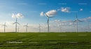 Wind Turbines on a Green Field Under a Blue Sky