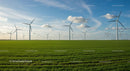 Wind Turbines in a Vast Green Field Under a Clear Blue Sky