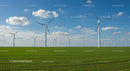 Wind Turbines in Green Field Under Blue Sky