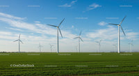 Wind Turbines in Green Field Under Blue Sky