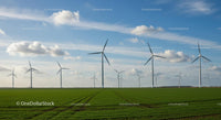 Wind Turbines on a Green Field under Blue Sky