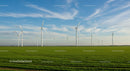 Wind Turbines on a Sunny Day Across a Vast Green Field