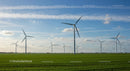 Wind Turbines in Green Field Under Blue Sky