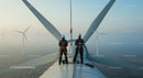 Technicians Inspecting Wind Turbine at Sunrise