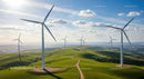 Wind Turbines on Rolling Green Hills Under Blue Sky