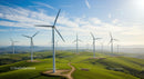 Wind Turbines on Lush Green Hills Under Clear Blue Sky