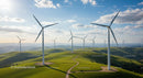 Wind Turbines on Rolling Green Hills Under Blue Sky