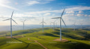 Wind Turbines on Scenic Green Hills Under Blue Sky