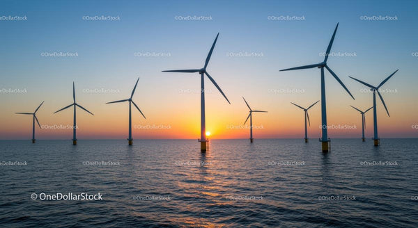 Morskie turbiny wiatrowe podczas żywego zachodu słońca nad oceanem