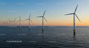 Offshore Wind Turbines at Sunset Over the Ocean