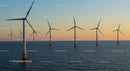 Offshore Wind Turbines at Sunset on the Ocean Horizon