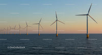 Offshore Wind Turbines at Sunset Over Calm Sea