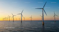 Offshore Wind Turbines at Sunset Over Calm Sea